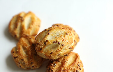 Mini pies with sesame seeds on white background © splitov27