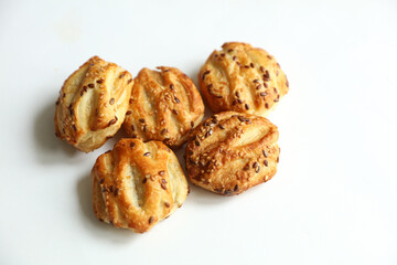 Mini pies with sesame seeds on white background © splitov27
