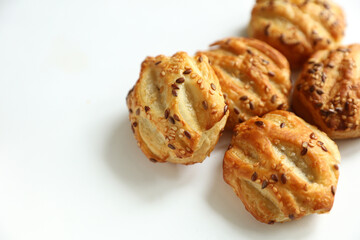 Mini pies with sesame seeds on white background © splitov27