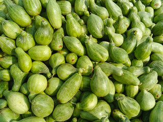 Fresh harvested green cucumbers also known as khera stacked together showcasing natural texture and vibrant green shades. Ideal for use in food blogs and healthy life style.  cucumbers in market