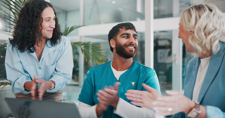 Applause, laptop and medical with hospital administration team in boardroom for celebration. Computer, meeting or success with healthcare staff and manager clapping in clinic for achievement or goals