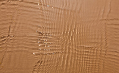 Wavy water texture on brown background