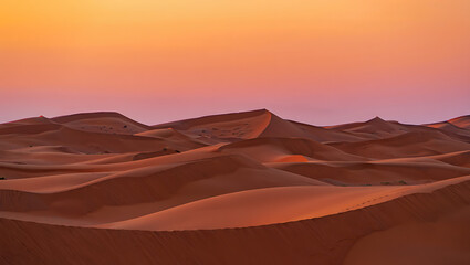 Fototapeta premium Fiery orange and red hues paint the dramatic Sahara landscape, as the sun dips below the rolling sand dunes