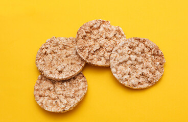 Rice round crackers, diet bread on yellow background