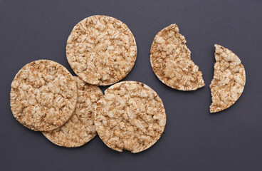 Rice round crackers, diet bread on dark gray background