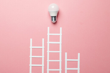 Paper stairs and light bulb on pink background. Creative idea. Business concept