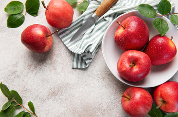 Fresh red apples with water drops in bowl on kitchen table