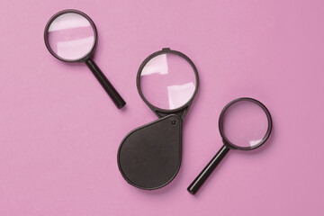 Set of magnifiers on pink background
