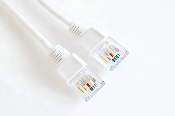 Two white ethernet cables with rj45 connectors against a bright white background