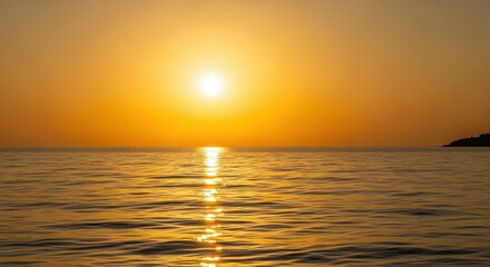 Obraz premium Golden Sunset over the Ocean: The sun descends over the horizon, casting a golden glow across the calm waters. It's the time of day for tranquility.