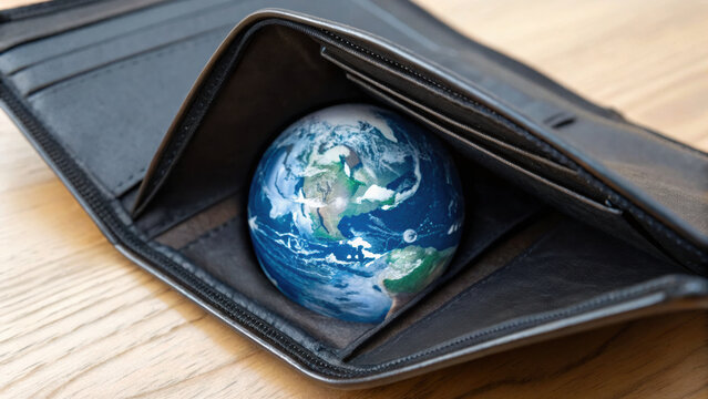 Wallet holding globe symbolizes economic risk and critical global financial issues with creative and thought provoking mood, highlighting importance of worldwide money management