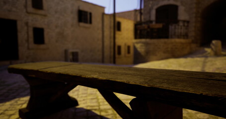 A rustic wooden bench is illuminated by soft evening light in a quaint cobblestone alleyway. Surrounding stone buildings create a peaceful atmosphere at twilight.