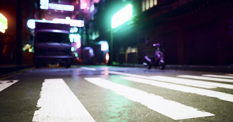 A dimly lit alley captures the energy of the city at night. Neon signs illuminate the surroundings, reflecting the urban vibe. A scooter rests in the foreground, showcasing city life.