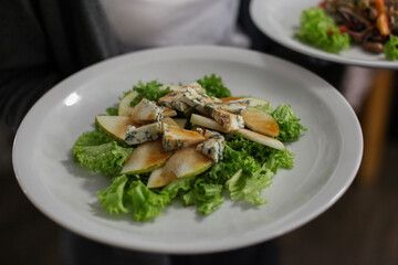 Delicious salad with pear, blue cheese, and lettuce
