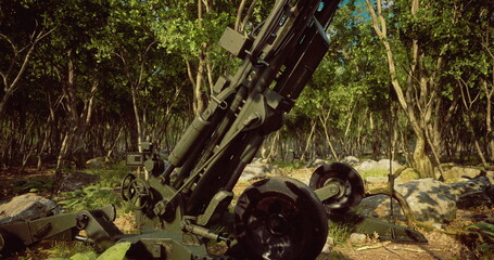 A powerful piece of artillery stands tall within a lush green forest, surrounded by rocks and trees. Sunlight filters through the leaves, highlighting the military equipment and the natural setting.