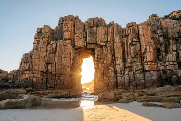 Sunlit arch in coastal rock formation at sunrise