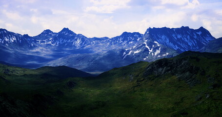 Fototapeta premium High mountains dominate the landscape, showcasing rugged terrain and snow covered summits under a blanket of clouds. Green valleys stretch below, highlighting natures beauty.