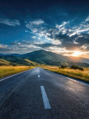 Naklejka premium Asphalt road leading into a mountain sunset (1)