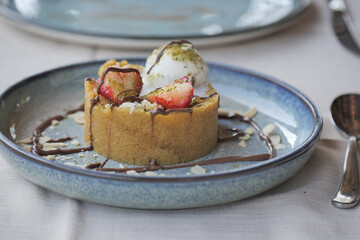 Delicious dessert with strawberries and ice cream served