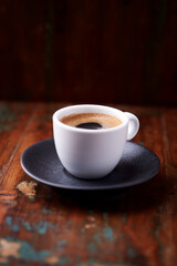 Cup of coffee on rustic wooden background. Soft focus. Copy space	