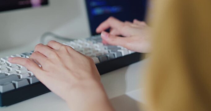 Closeup of young Asia female freelance eyeglasses type write prompt AI bot IT app smart program nomad, video game, terminal with coding, user interface, data center on desktop computer at home office.
