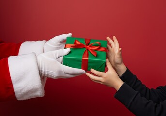 A holiday moment showing Santa's hand presenting a festive gift to a child's hand