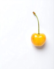 Single yellow cherry against white background
