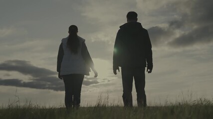 silhouette man and woman at sunset, hold partner's hand sun, teamwork, corporate happy farming group, successful business team, trust of successful people, joy of joining unity, raise your hands up.