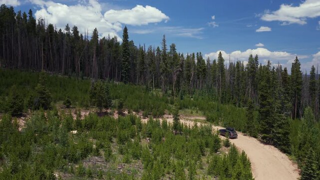 Mount of the Holy Cross AWD car driving dirt road car aerial drone Rocky Mountains Colorado Notch Mountain creek Falls Creek Trail Half moon pass Vail Minturn summer morning blue sky forward follow