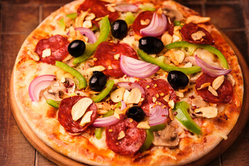 Pizza with salami, mozzarella cheese and jalapeno pepper. Wooden background. Soft focus.	