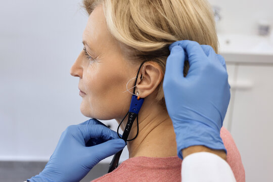 Hearing solutions. Audioprosthetist adjusts the patient's hearing aids using special equipment, and takes real ear measurements