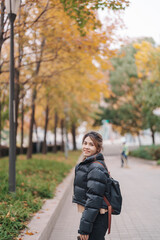 Fototapeta premium woman traveler visiting in Shanghai, China. Happy Female Tourist sightseeing Shanghai view in The Bund of Shanghai in Autumn season. landmark and popular for tourism attractions. Travel and Vacation