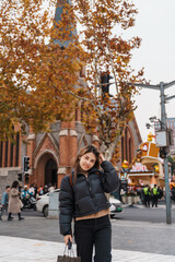 Obraz premium woman traveler visiting in Shanghai, China. Happy Female Tourist sightseeing Shanghai Union Church view in autumn season. landmark and popular for tourism attractions. Travel and vacation