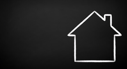 Fototapeta premium Drawn outline of a house in white chalk on a black chalkboard background.