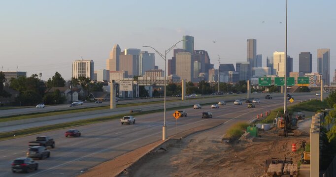 Ascending drone shot of 288 Freeway Traffic with Houston Cityscape