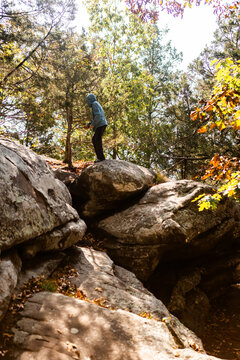 Child climbing on boulders during autumn at Garden of the Gods