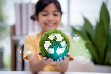 A smiling child holding a green globe with recycle symbol and eco icons. Concept of sustainability, renewable energy, zero emission, green technology, and environmental protection future.