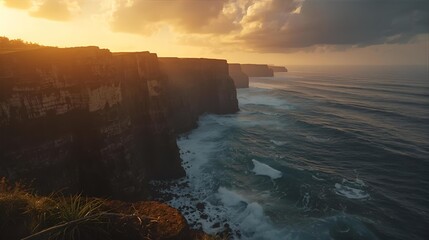A stunning coastal landscape featuring majestic cliffs and the vast ocean during a spectacular golden sunset