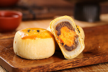 Chinese Mooncakes with Egg Yolk Red Bean Paste Filling Traditional Dessert Display on Wooden Board
