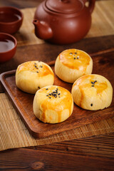 Chinese Egg Yolk Pastries with Black Sesame Seeds on Wooden Serving Tray Traditional Asian Dessert