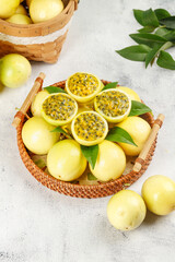 Fresh Golden Passion Fruits from Guangxi China in Wicker Basket with Green Leaves