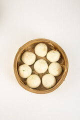 Chinese Steamed Buns in Bamboo Steamer Basket on White Background - Traditional Dim Sum Dumplings
