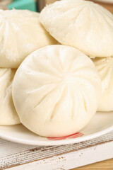 Handmade Steamed Buns with Meat Filling and Sauce - Traditional Asian Dumplings on White Plate