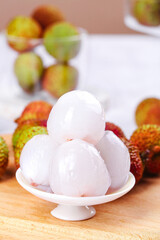 Fresh Peeled Lychee Fruits on White Plate with Tropical Fruit Background - Asian Exotic Delicacy