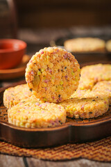 Hakka Five Grain Puff Pastries with Roasted Nuts and Purple Potato on Wooden Plate - Traditional Chinese Cuisine