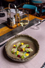 Raw white fish with jalapeño peppers served in a restaurant