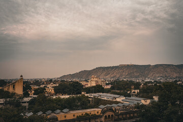 Obraz premium Moody cityscape of Jaipur with Jantar Mantar and Aravalli hills in view, Rajasthan, India