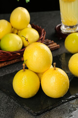 Fresh Golden Passion Fruits from Hainan Fujian China with Juice Glass on Dark Slate Board