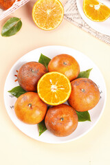 Fresh Ripe Oranges with Green Leaves on White Plate - Healthy Citrus Fruit Display