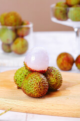 Fresh Hainan Lychee Fruits with Peeled Translucent Flesh on Wooden Cutting Board - Tropical Asian Delicacy